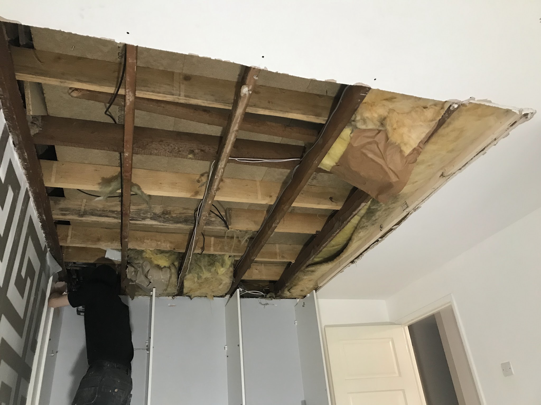 An old ceiling taken down to the joists, ready for insulation and new boards